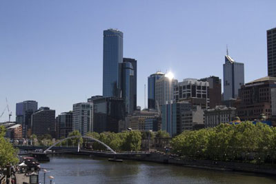 Melbourne Australia's cityscape and the Yarra River on a sunny day. Discover how to move to a new city alone and have a wonderful time.